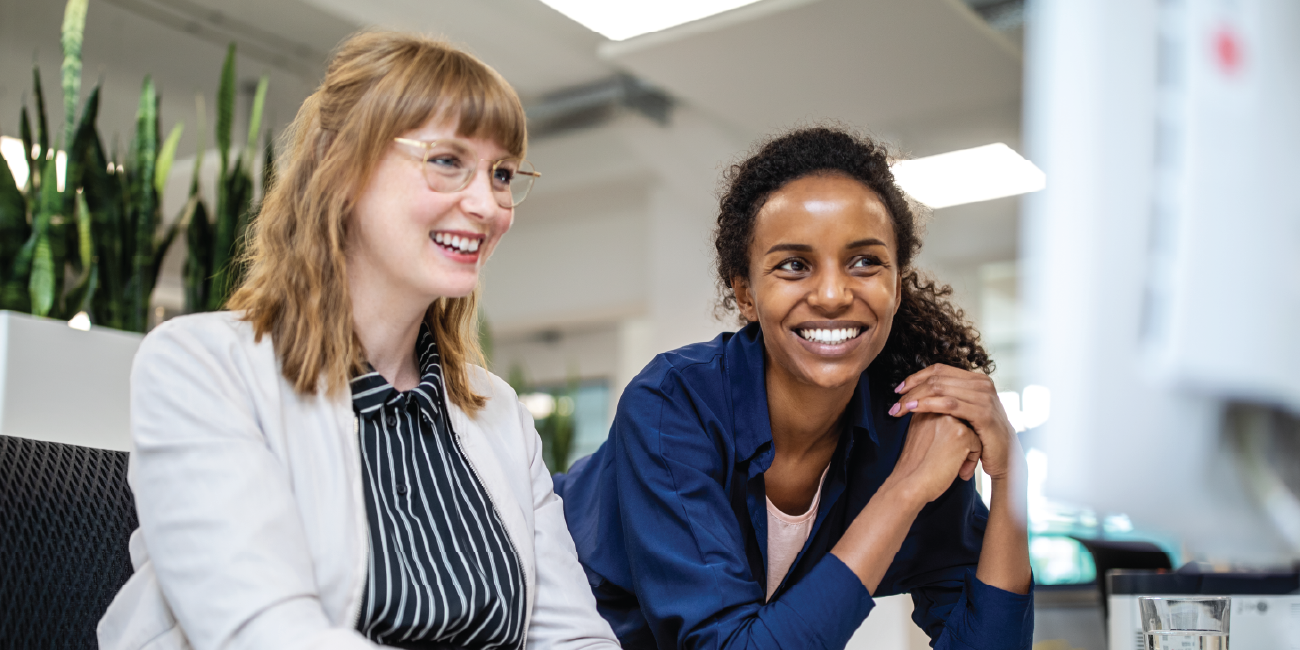 Smiling teammates discussing a project